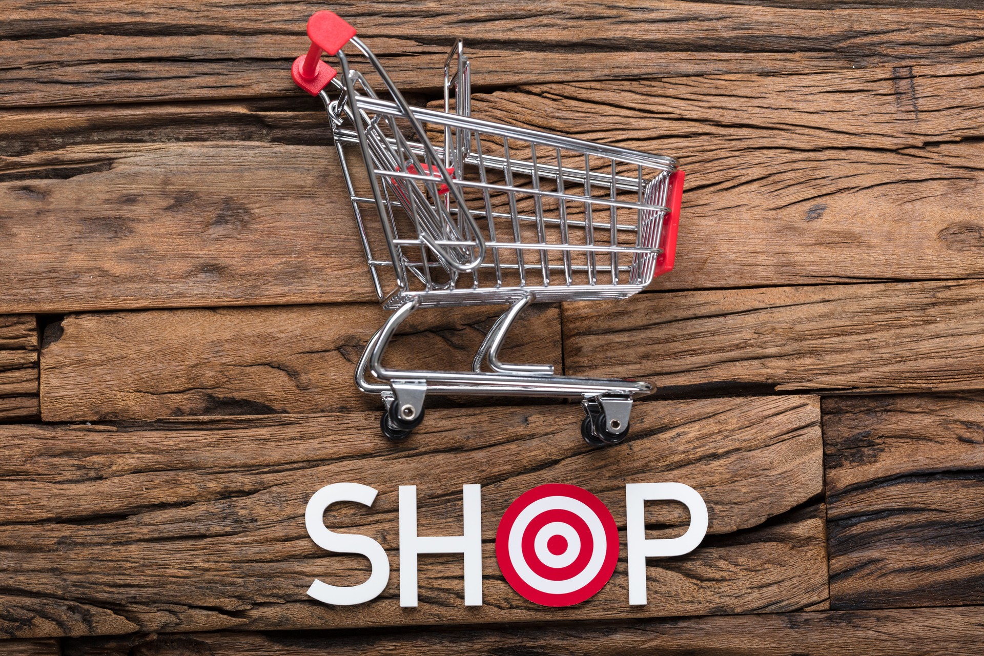 Shop Text With Dartboard On Wooden Table